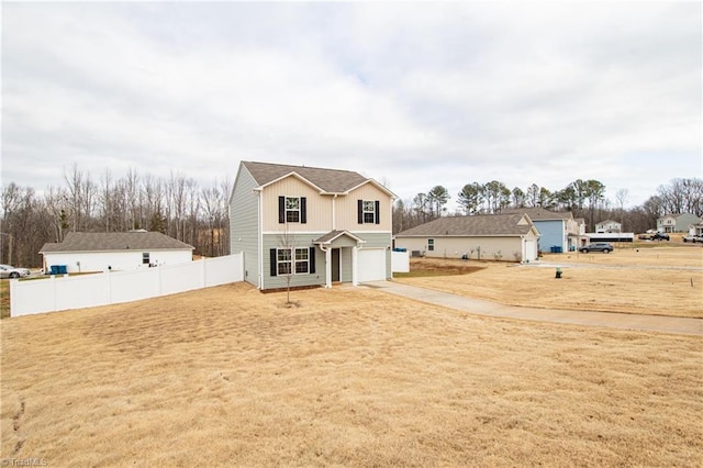 traditional-style home featuring board and batten siding, a front lawn, fence, and a garage