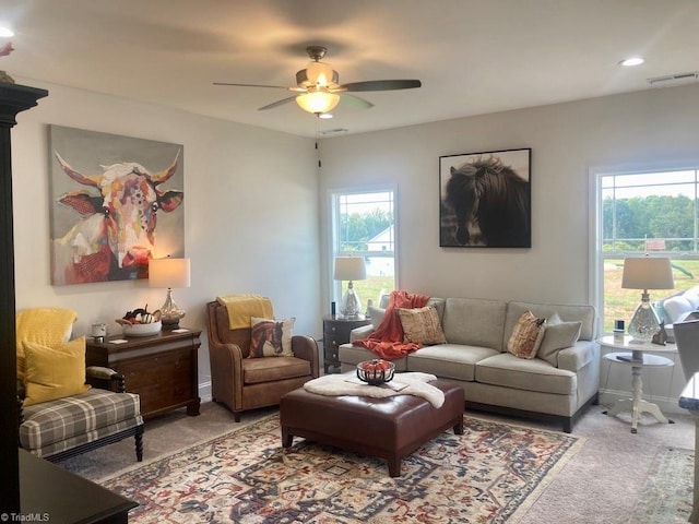 carpeted living room featuring ceiling fan