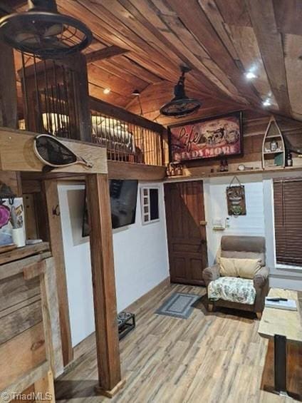 interior space featuring hardwood / wood-style flooring, vaulted ceiling, and wooden ceiling