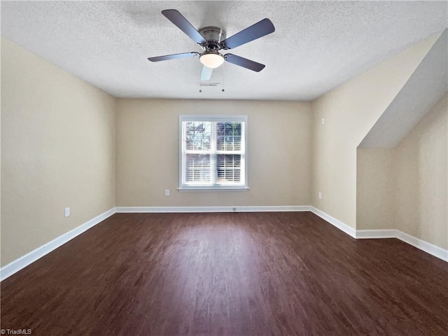 additional living space with visible vents, baseboards, a textured ceiling, and wood finished floors