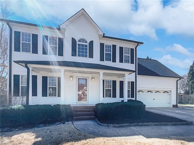 view of front of property featuring covered porch, driveway, and an attached garage