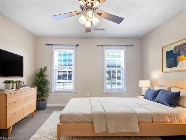 bedroom featuring visible vents, carpet floors, multiple windows, and baseboards