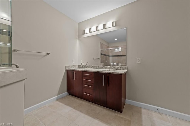 201 N Elm St Unit 703, Greensboro, NC 27401 - full bath with a shower stall, baseboards, and double vanity
