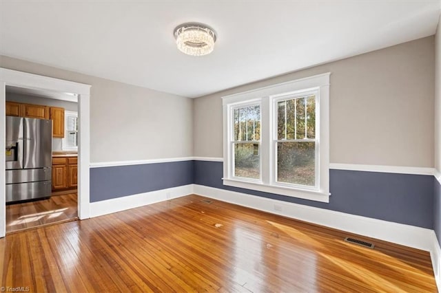 empty room with hardwood / wood-style flooring