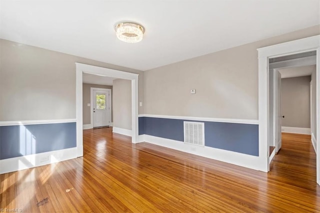 empty room featuring wood-type flooring
