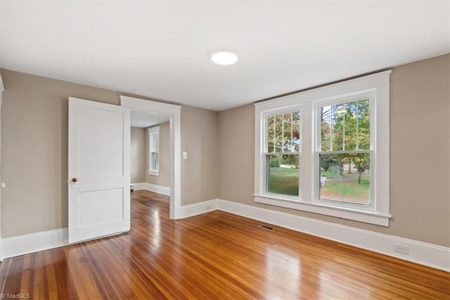 spare room featuring hardwood / wood-style floors