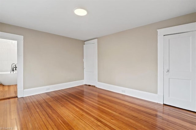 spare room featuring wood-type flooring