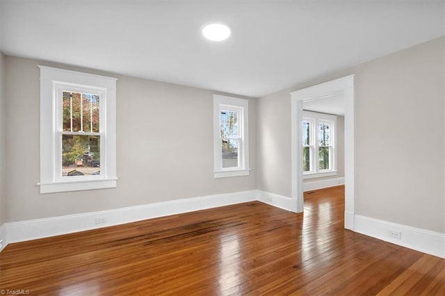 unfurnished room with hardwood / wood-style flooring