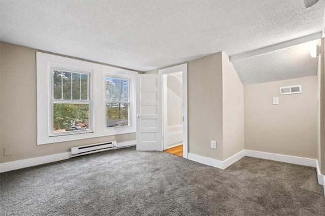 additional living space featuring a textured ceiling, carpet flooring, and a baseboard heating unit
