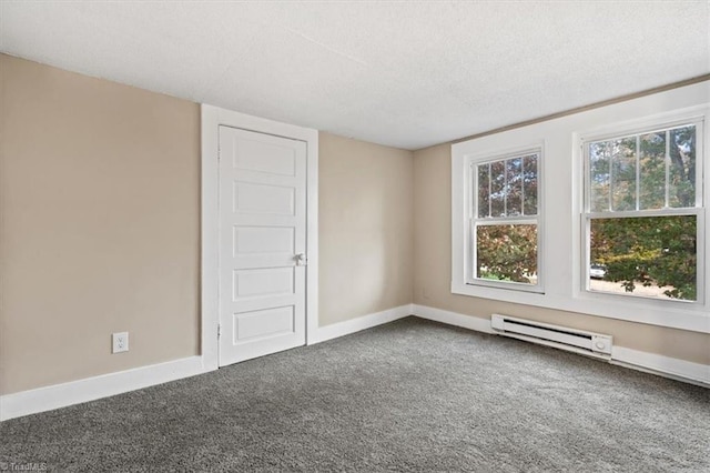empty room with a baseboard radiator, a textured ceiling, and carpet floors