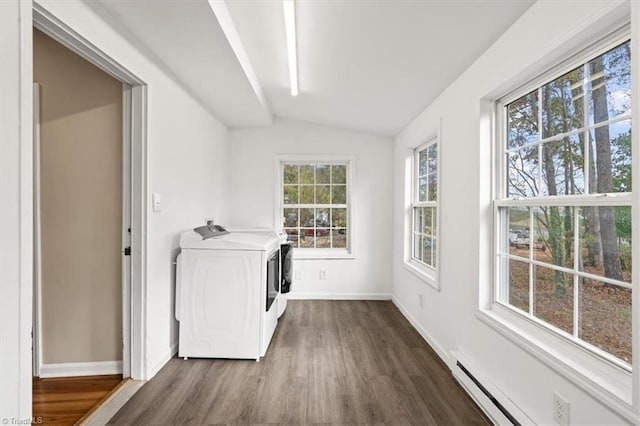 washroom with baseboard heating, dark wood-type flooring, and washing machine and dryer