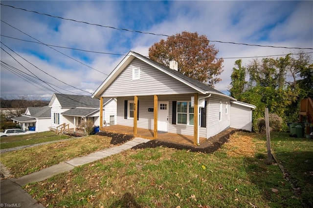 bungalow with a porch and a front yard