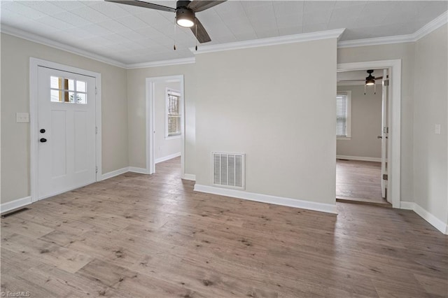 entrance foyer with ornamental molding, light wood-type flooring, and ceiling fan