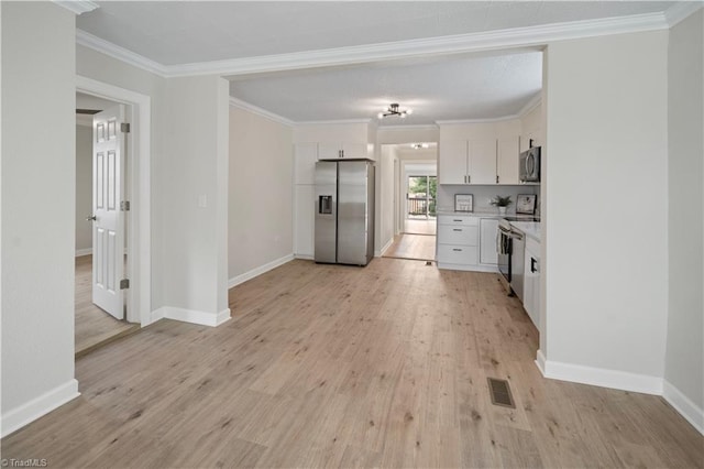 kitchen with light hardwood / wood-style floors, white cabinets, crown molding, and stainless steel appliances