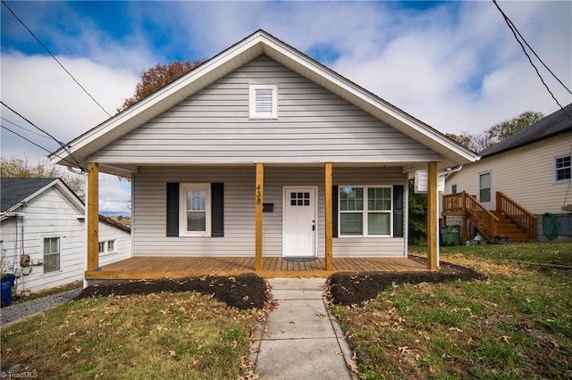 bungalow featuring a front lawn and covered porch