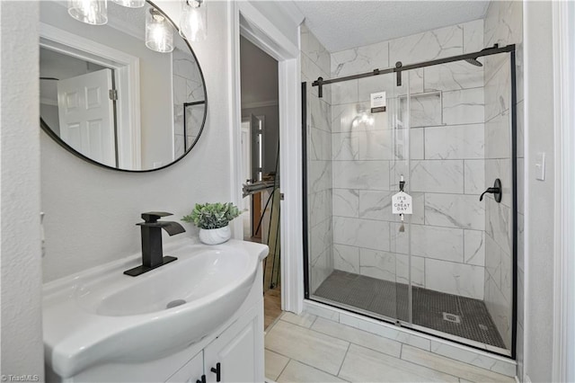 bathroom with vanity, a textured ceiling, tile patterned floors, and a shower with door