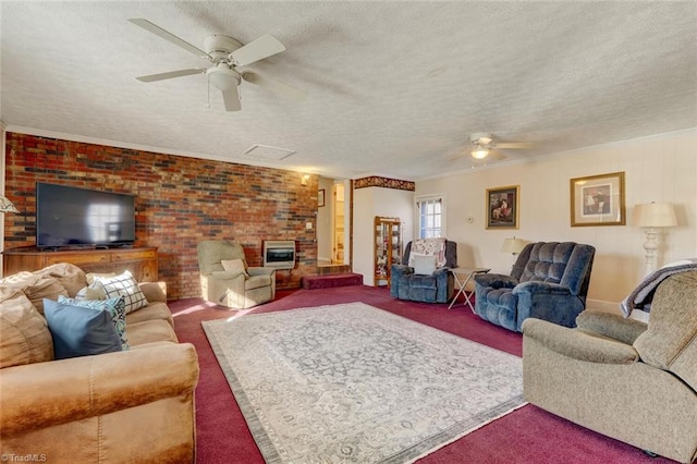 carpeted living room featuring a textured ceiling, ornamental molding, ceiling fan, and brick wall