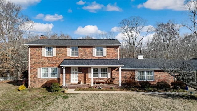 view of property with a front yard and a patio area