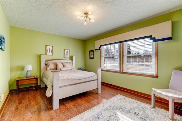 bedroom featuring a textured ceiling and hardwood / wood-style floors