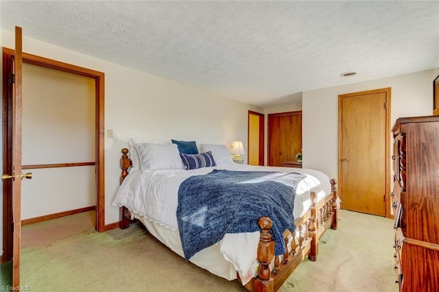 carpeted bedroom with a textured ceiling