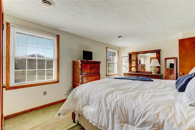 carpeted bedroom featuring a textured ceiling