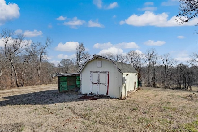 view of outbuilding featuring a lawn