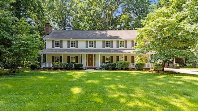 2424 Limner Ln, Winston-Salem, NC 27106 - colonial house featuring a chimney, covered porch, and a front yard