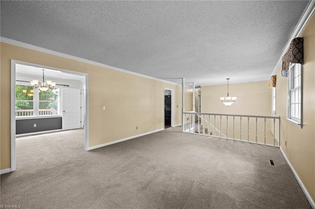 2424 Limner Ln, Winston-Salem, NC 27106 - empty room with a chandelier, carpet flooring, crown molding, a textured ceiling, and baseboards