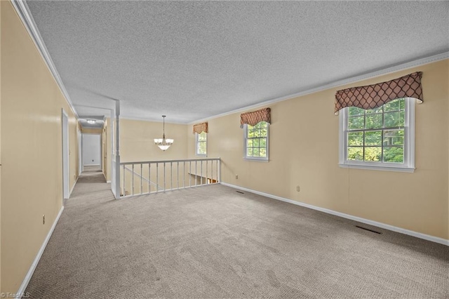 2424 Limner Ln, Winston-Salem, NC 27106 - empty room featuring a chandelier, ornamental molding, carpet flooring, a textured ceiling, and baseboards