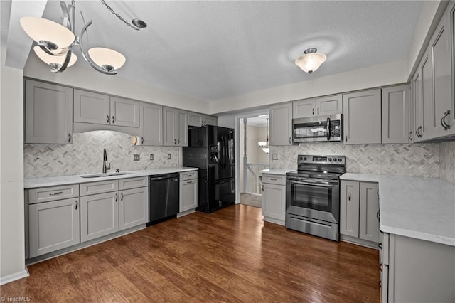 2424 Limner Ln, Winston-Salem, NC 27106 - kitchen with black appliances, gray cabinetry, a sink, decorative backsplash, and a textured ceiling