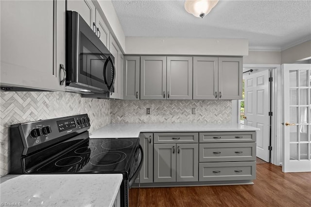 2424 Limner Ln, Winston-Salem, NC 27106 - kitchen with black appliances, gray cabinets, a textured ceiling, dark wood-style floors, and light countertops