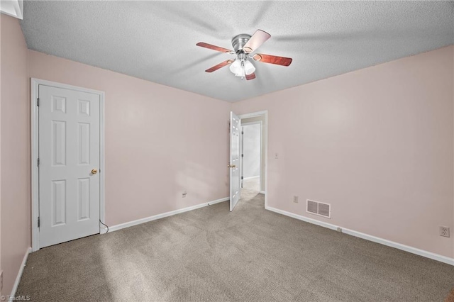 2424 Limner Ln, Winston-Salem, NC 27106 - unfurnished bedroom with baseboards, carpet, a textured ceiling, and a ceiling fan