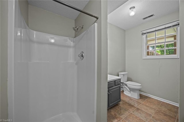 2424 Limner Ln, Winston-Salem, NC 27106 - full bathroom featuring a textured ceiling, baseboards, a shower, vanity, and toilet