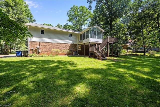 2424 Limner Ln, Winston-Salem, NC 27106 - back of property featuring a sunroom, stairs, brick siding, a lawn, and a deck