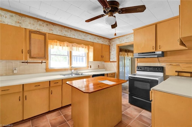 kitchen featuring black appliances, sink, a kitchen island, ceiling fan, and light tile patterned floors