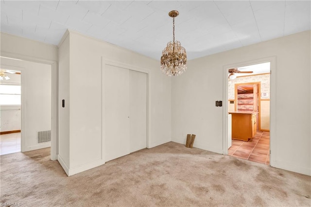 interior space with light carpet and ceiling fan