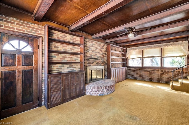 unfurnished living room with a wealth of natural light, carpet floors, and wooden ceiling