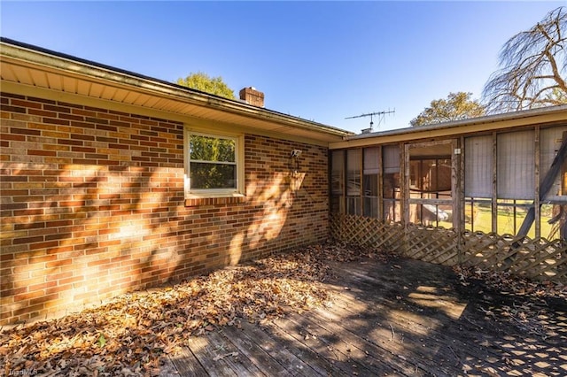 view of property exterior with a deck