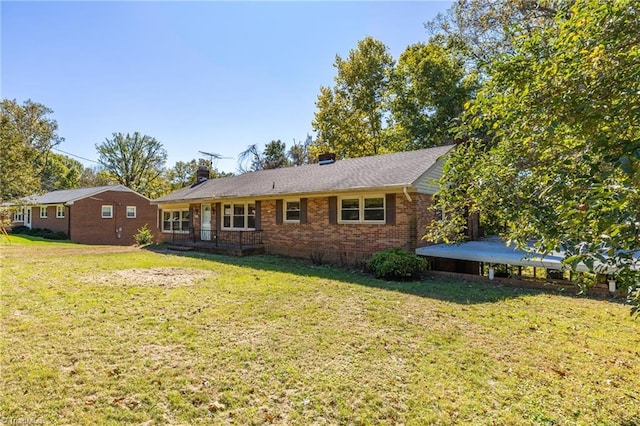 rear view of house featuring a yard