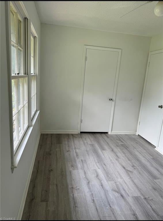 567 Townsend St, North Wilkesboro, NC 28659 - unfurnished room featuring wood finished floors, baseboards, and a textured ceiling