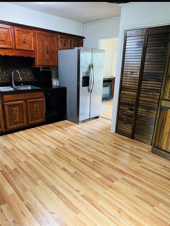 567 Townsend St, North Wilkesboro, NC 28659 - kitchen featuring a sink, stainless steel fridge, dishwasher, dark countertops, and light wood-style floors