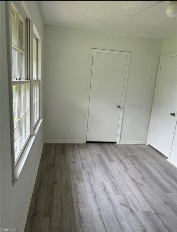567 Townsend St, North Wilkesboro, NC 28659 - spare room with healthy amount of natural light, wood finished floors, baseboards, and a textured ceiling