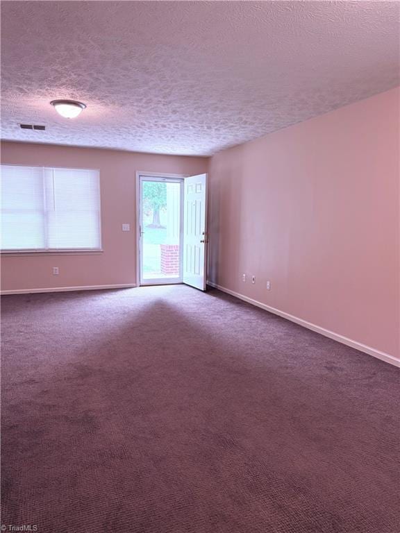 1770 Inglebrook Trl, Mount Airy, NC 27030 - spare room featuring a textured ceiling, baseboards, and dark colored carpet
