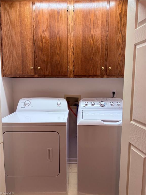 1770 Inglebrook Trl, Mount Airy, NC 27030 - laundry room featuring independent washer and dryer, cabinet space, and tile patterned floors