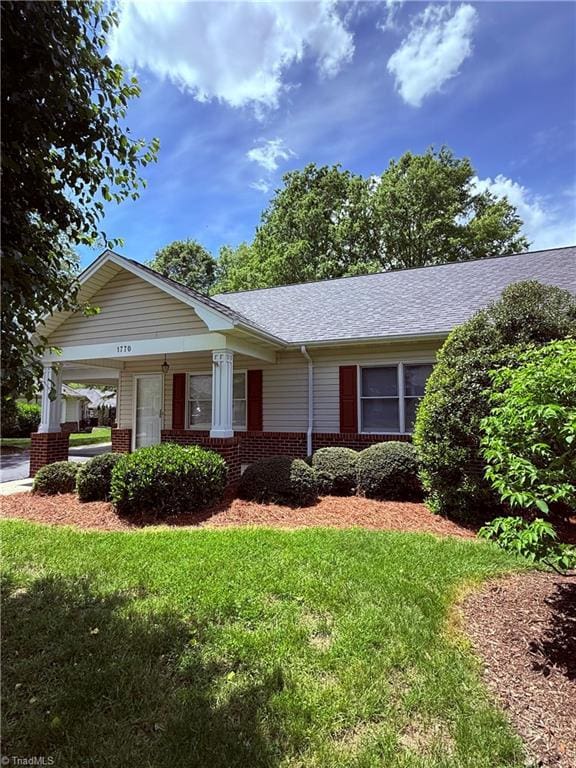 1770 Inglebrook Trl, Mount Airy, NC 27030 - view of front of house featuring brick siding, a front lawn, a porch, and roof with shingles
