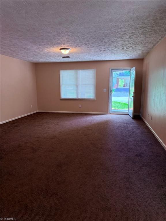 1770 Inglebrook Trl, Mount Airy, NC 27030 - spare room featuring a textured ceiling, baseboards, and dark carpet