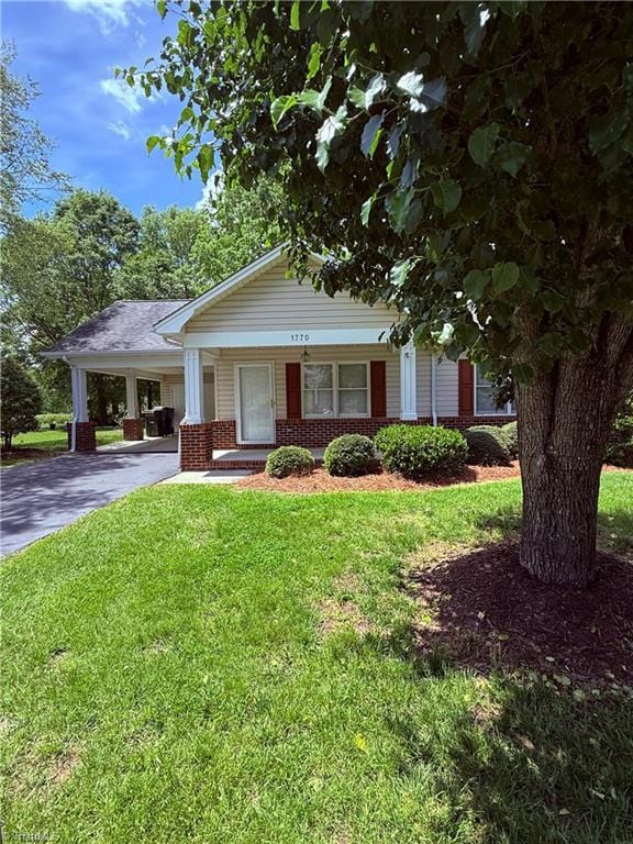 1770 Inglebrook Trl, Mount Airy, NC 27030 - view of front of home with brick siding, concrete driveway, a front lawn, and a carport