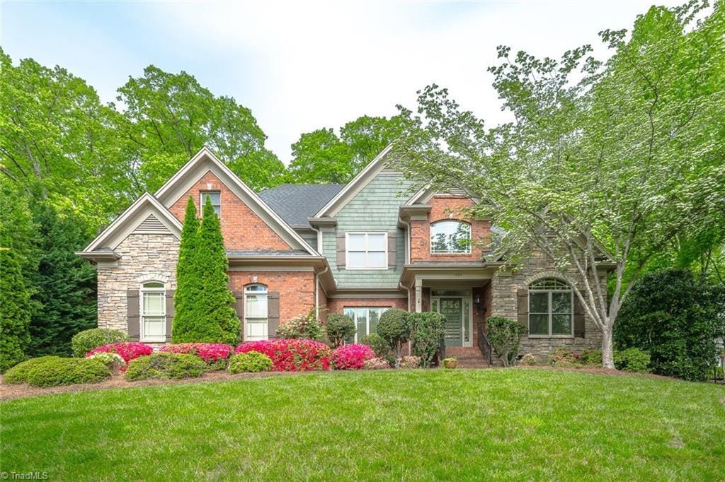 1425 Willow Woods Way, Winston-Salem, NC 27104 - craftsman house with a front lawn and brick siding