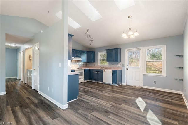 kitchen with white appliances, light countertops, blue cabinets, under cabinet range hood, and a notable chandelier