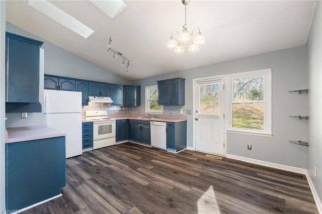 kitchen with blue cabinetry, under cabinet range hood, light countertops, white appliances, and a sink